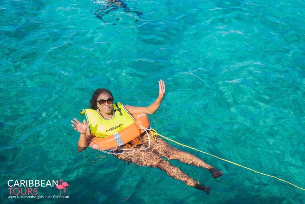 Snorkeler floats in the turquoise water off the coast of Aruba
