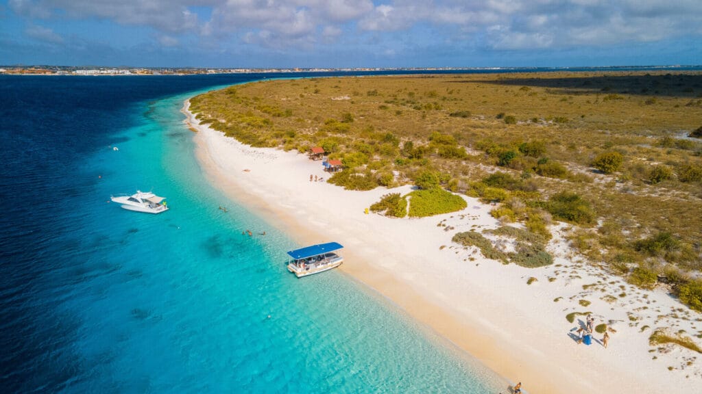 Aerial view of Klein Bonaire with white beach, turquoise sea, and boats.